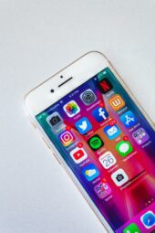 An iphone with apps riddled with notifications, which causes distractions (Success Through Failure: Episode 291 Logically Override the Default: How to Stop Procrastinating, Scrolling, and Getting Distracted)