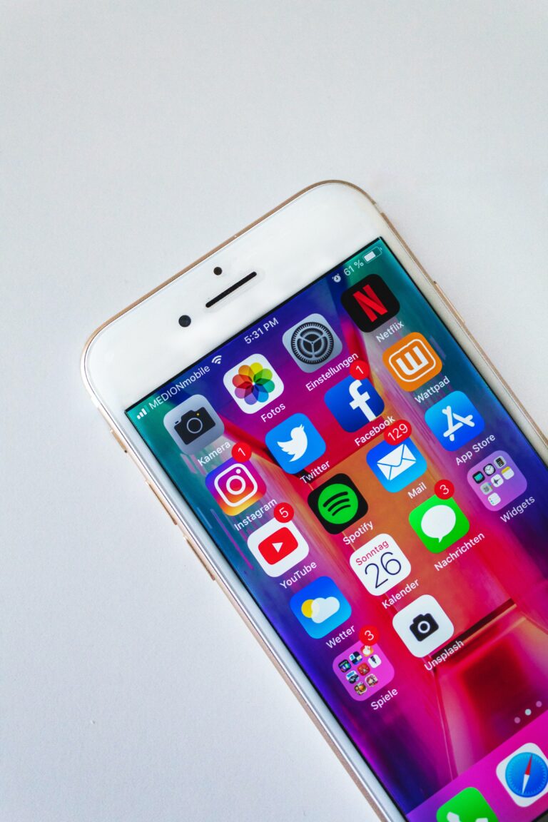 An iphone with apps riddled with notifications, which causes distractions (Success Through Failure: Episode 291 Logically Override the Default: How to Stop Procrastinating, Scrolling, and Getting Distracted)