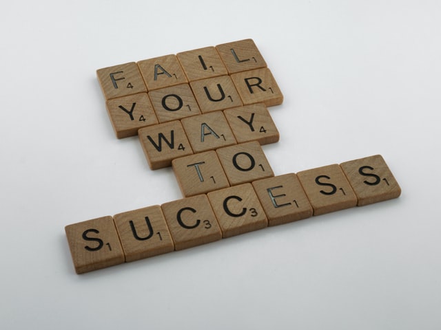 Scrabble blocks that spell out, " Fail your way to success." (Success Through Failure episode 298: 3 Proven Ways to Transform Failure into Success)