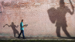 A David and Goliath-like image: The small man ready to take on the big challenges in his life (Success Through Failure episode 302: Overcoming Your Fear of Setting Scary BIG Goals: How to Set Your BHAG) 