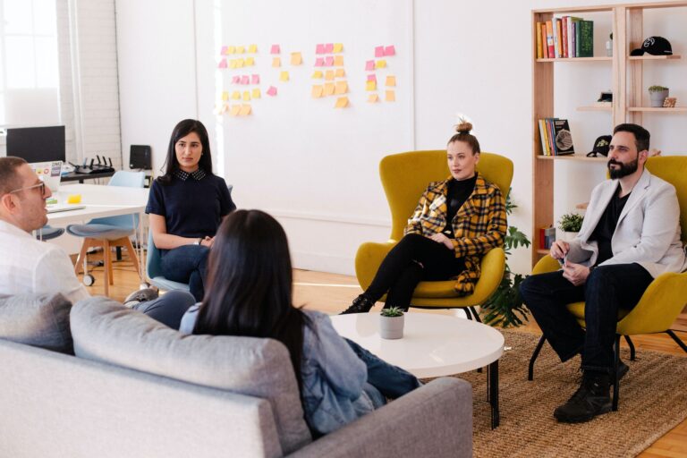 Five people having a meeting (Success Through Failure episode 308: How Masterminds Work and How to Start Your Own)