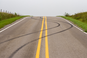 A pavement with a swerving tire marks (Success Through Failure episode 352: 3 Essential Tips for Staying on Track (Even When the Track is Always Changing))