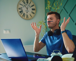 A distracted man sitting in front of a laptop (Success Through Failure episode 373: #373 What To Do About Unproductive Days)