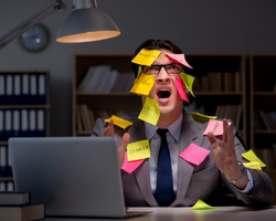 A frustrated man with multiple sticky notes stuck on his body (Success Through Failure episode 381: The Solution for Information Overload: 5 Timeless and Essential Success Principles)