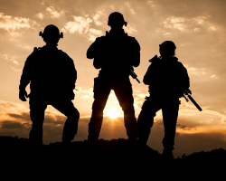 Silhouettes of 3 Navy SEALs with the sun setting in the background (Success Through Failure podcast episode 412: 7 Navy SEALs, 7 Lessons: How Failure Fuels Success)